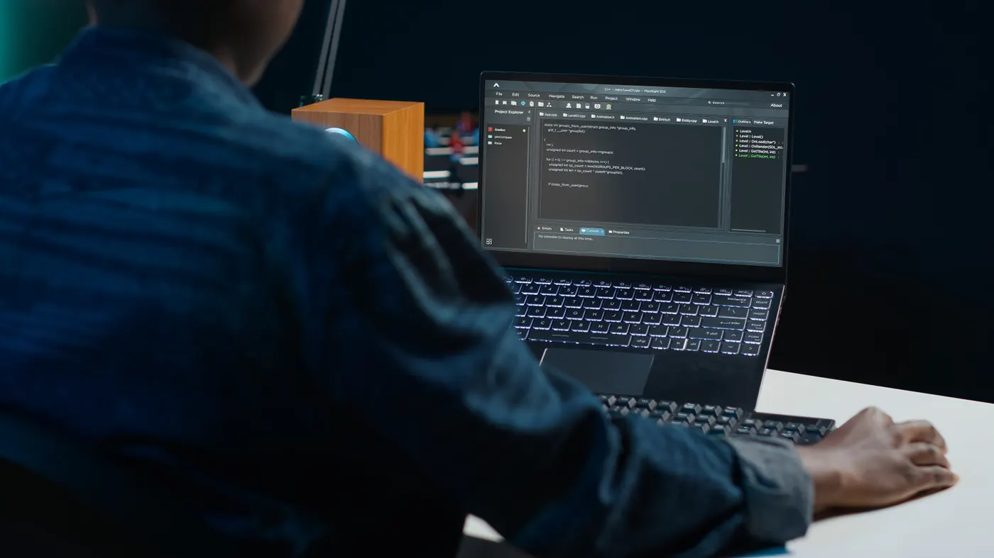 Developer writing code on a laptop