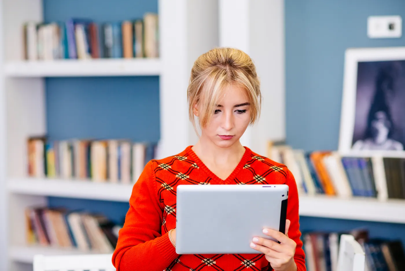 Student using a tablet in a library