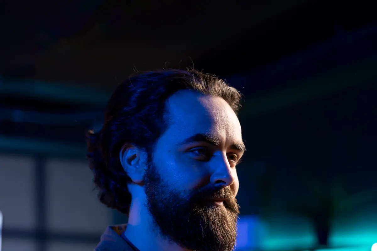 Engineer testing software on a laptop in blue light