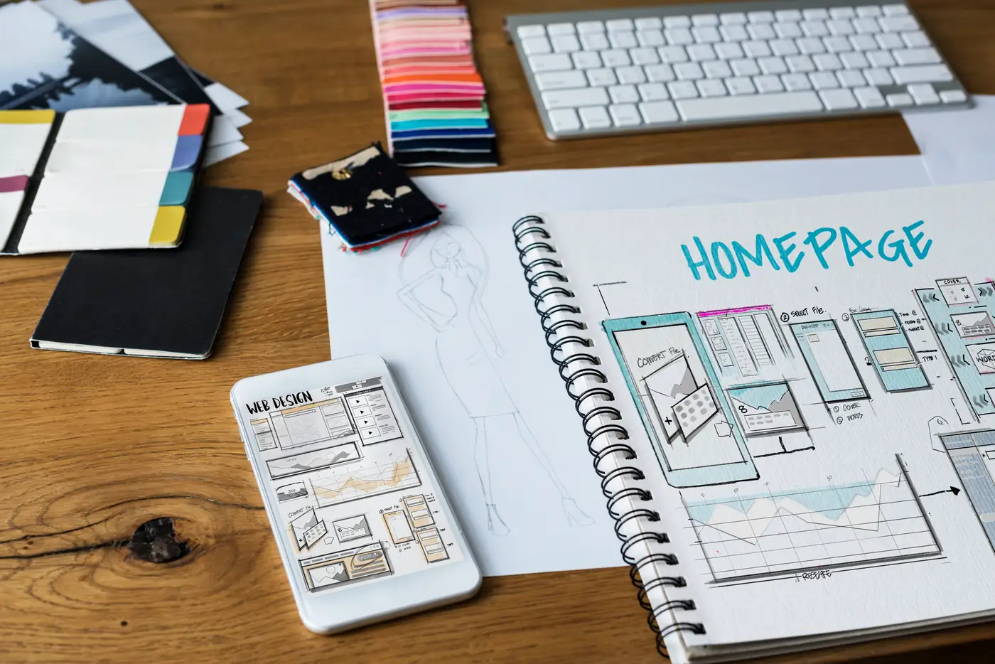 UI wireframe sketches spread across a desk